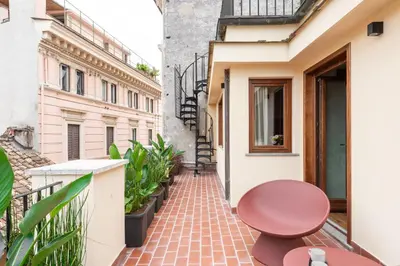 a hallway with a staircase with a black door at Residenza Leutari in Rome