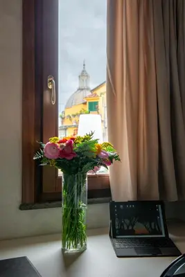 a kitchen with a counter and a sink and a window at Residenza Leutari in Rome