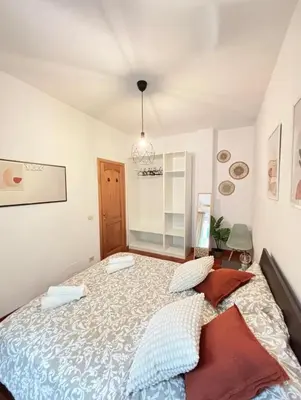 a bedroom with a large bed in a room at Saulo Guest House - A 10 minuti da Colosseo in Rome