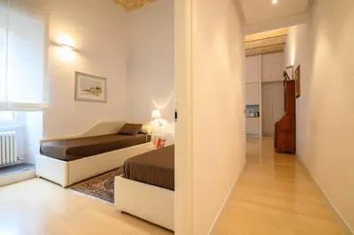 a small bedroom with a bed and a mirror at Gracchi Apartment Prati in Rome