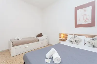 a bedroom with two beds with towels on the bed at via Madonna del Riposo in Rome