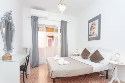a white bedroom with a bed and a window at via Madonna del Riposo in Rome