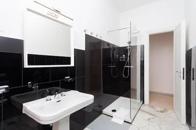 a black and white bathroom with a sink and a shower at via Madonna del Riposo in Rome