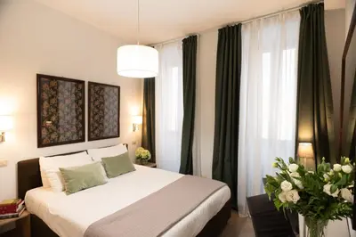 a bedroom with a large bed with green curtains at Banchi Vecchi Stay Apt Suite Navona in Rome