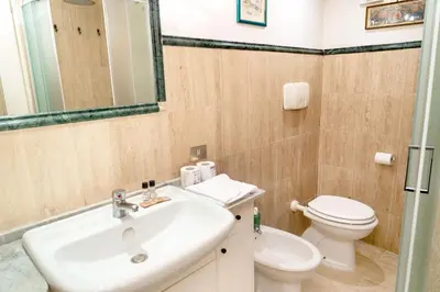 a bathroom with a sink and a toilet at Colosseum Charming Loft - Santa Maria in Carinis in Rome