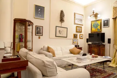 a living room with two couches and a tv at Colosseum Charming Loft - Santa Maria in Carinis in Rome