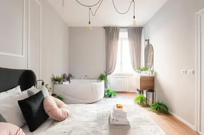 a bathroom with a tub and a large window at Termini apartments in Rome