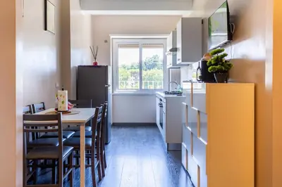 a kitchen with a table and a dining room at Cipro Vatican House in Rome