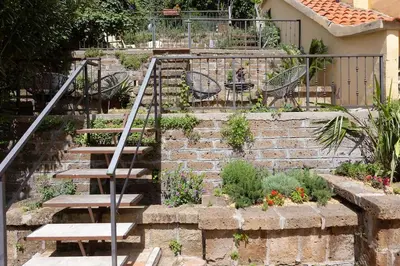 a set of stairs in a garden with benches at Appartamento San Pietro-Vaticano in Rome