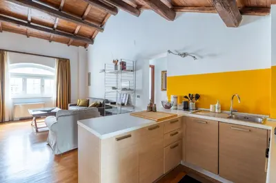 a kitchen with yellow walls and wooden cabinets at Baccina 45 - Cozy Quiet Apt in Rome