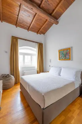 a bedroom with a large bed and a window at Baccina 45 - Cozy Quiet Apt in Rome