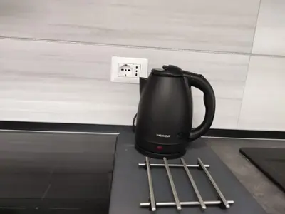 a black coffee pot sitting on a counter next to a socket at ROMAN'S HOUSE in Rome