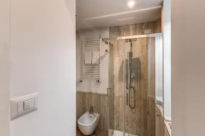a bathroom with a shower with a toilet and a sink at Domus Sabina in Rome