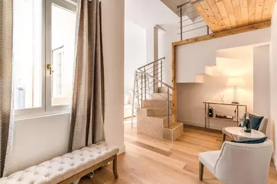 a living room with a chair and a stairway at Domus Sabina in Rome