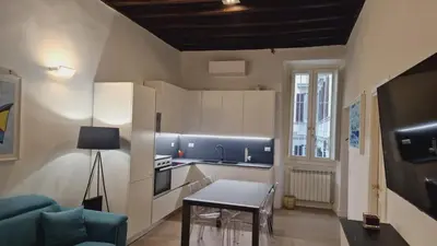 a kitchen with a couch and a table in a room at Borgo Pio 182 Vatican Suite in Rome