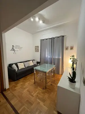 a living room with a couch and a glass table at Balduina View in Rome