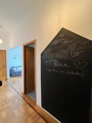 a chalkboard on the wall of a room with a bed at Balduina View in Rome