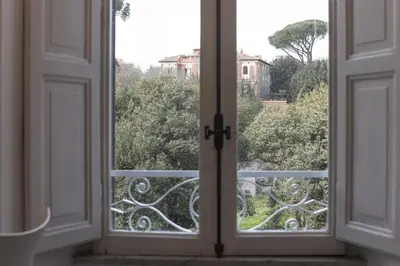 an open window with a view of a house at Casa Albani in Rome