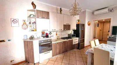 a kitchen with a refrigerator and a stove top oven at Bribry Home in Rome