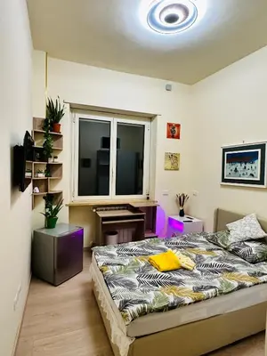 a bedroom with a bed and a desk and a window at Sanpaolo Modern Aesthetic B&B in Rome
