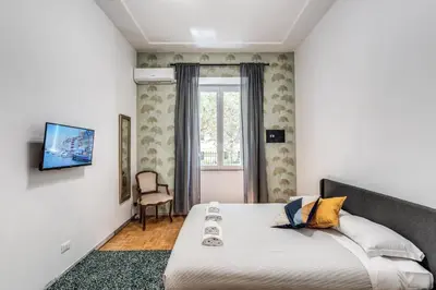a bedroom with a large bed and a window at Residenza Nemorense in Rome