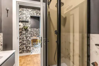 a shower with a glass door in a bathroom at Residenza Nemorense in Rome