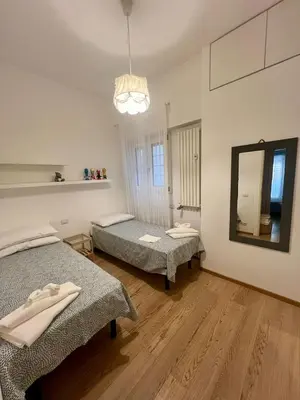 a room with two beds and a mirror in it at La casa di Rosina al Pigneto in Rome