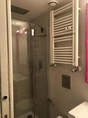 a bathroom with a shower with a glass shower door at La casa di Rosina al Pigneto in Rome