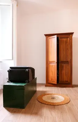a suitcase sitting on top of a box on a wooden floor at Bright Vatican Apartment in Rome