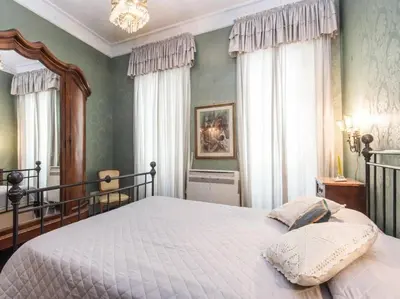 a bedroom with a bed and a chandelier at Luxury Apartment Spanish Steps in Rome