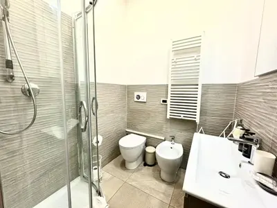 a bathroom with a shower and a toilet and a sink at Maison Borghetto - Vatican Flat in Rome