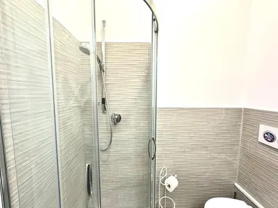 a shower stall in a bathroom with a toilet at Maison Borghetto - Vatican Flat in Rome