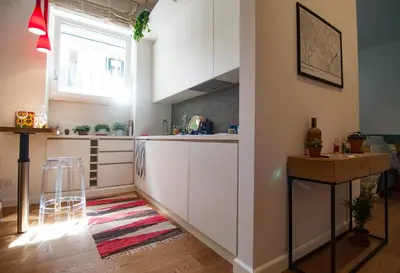 a kitchen with white cabinets and a window at Perfect Hideout in Trastevere in Rome