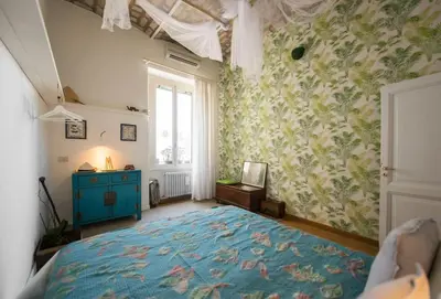 a bedroom with a bed with a blue rug at Vatican Dolce Vita in Rome