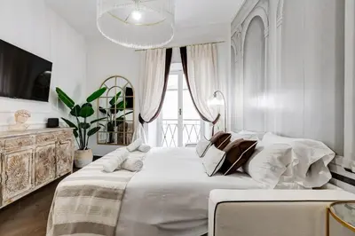 a white bedroom with a large bed and a window at NEXT TO SPANISH SQUARE - RomeDreamHome in Rome
