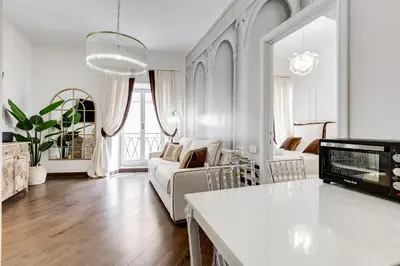 a white living room with a couch and a tv at NEXT TO SPANISH SQUARE - RomeDreamHome in Rome