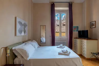 a bedroom with a large bed and a window at JOIVY Window on the Tevere in Rome