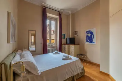 a bedroom with a bed and a window at JOIVY Window on the Tevere in Rome