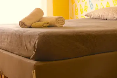 a bed with two towels on top of it at Rome Sleep Home Bed & Breakfast in Rome
