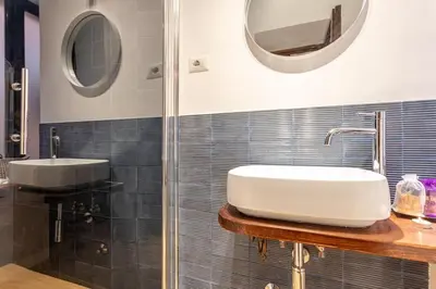 a bathroom with a sink and a shower at 18 Ciancaleoni House in Rome