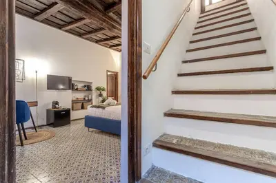 a bedroom with a bed and stairs in a room at 18 Ciancaleoni House in Rome