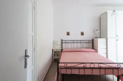 a bedroom with a bed with a red blanket at Vatican Cosy Apartment in Rome