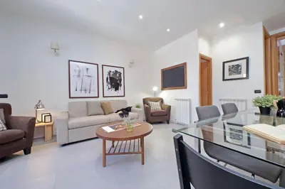a living room with a couch and a table at Monte del Gallo Apartment for groups in Rome