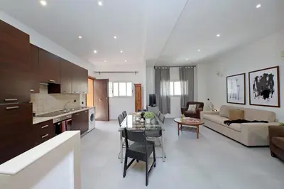 a kitchen and living room with a couch and a table at Monte del Gallo Apartment for groups in Rome