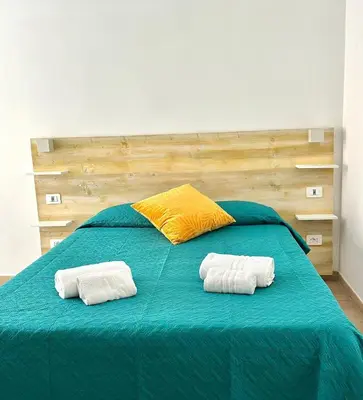 a bedroom with a bed with two towels on it at Domus Turno by Local Domus in Rome