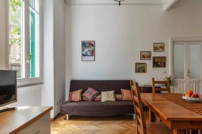 a living room with a couch and a table at Casa Dandolo - Pretty Homes in Rome