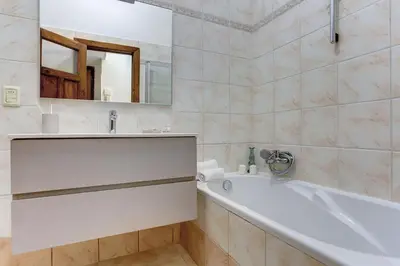 a bathroom with a tub and a sink and a mirror at Vatican Apt Doria 64 - Home and More in Rome
