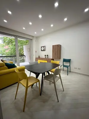 a dining room with a table and yellow chairs at BALDO 352 HOME in Rome