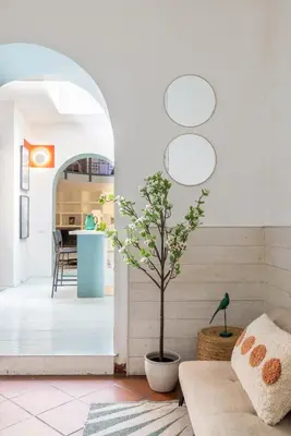 a living room with a potted tree sitting on a couch at Domus Fori Imperiali in Rome