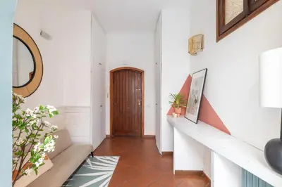 a hallway with white walls and a wooden door at Domus Fori Imperiali in Rome